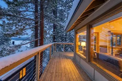 a balcony of a house with snow on the ground at Tahoe Vista Retreat with Lake View Walk to beach in Tahoe Vista