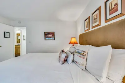 a white bedroom with a large bed with pillows at Modern 3BD -Walk to Lake & Beach in Tahoe City