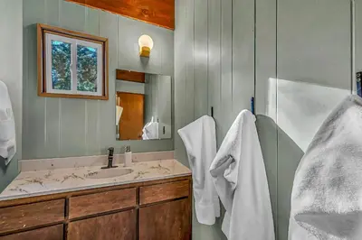a bathroom with a sink and a mirror at The Haus of Pine A Vintage Tahoe Cabin in Tahoe City
