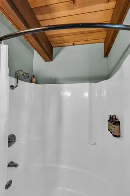 a bathroom with white walls and a wooden ceiling at The Haus of Pine A Vintage Tahoe Cabin in Tahoe City