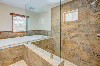 a bathroom with a tub and a glass shower at Lakeview Hideaway in Kings Beach