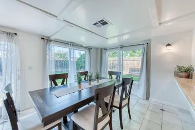 a dining room with a wooden table and chairs at Fig Garden 4BR House W Pool in Fresno