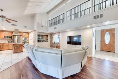 a living room with a couch and a tv at Fig Garden 4BR House W Pool in Fresno