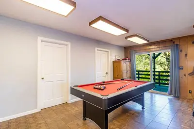 a room with a pool table in it at Sierra Vista Lookout Lodge with Creek, Waterfall and Waterholes, minutes from Bass Lake and Yosemite South Gate in North Fork
