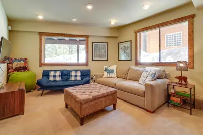 a living room with a couch and a chair at One Moose Lodge with Hot Tub in Tahoe Donner in Truckee