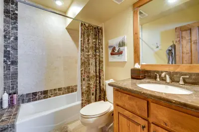 a bathroom with a toilet and a sink and a shower at One Moose Lodge with Hot Tub in Tahoe Donner in Truckee