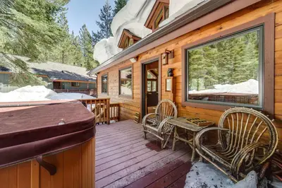 a wooden deck with a table and chairs on it at One Moose Lodge with Hot Tub in Tahoe Donner in Truckee