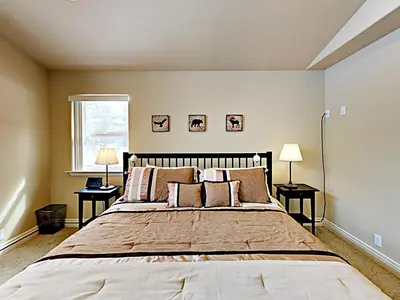 a bedroom with a large bed with two tables at Black Bear Cabin in South Lake Tahoe