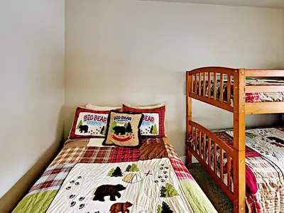 a bedroom with two beds and a bunk bed at Black Bear Cabin in South Lake Tahoe