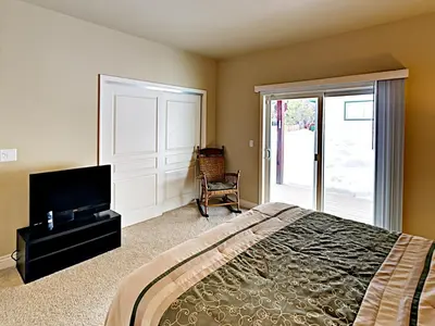 a bedroom with a bed and a tv and a window at Black Bear Cabin in South Lake Tahoe
