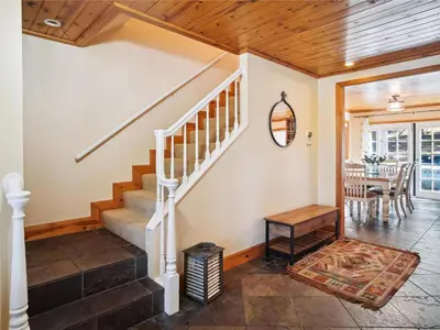 a staircase in a home with a wooden ceiling at High Sierra Escape - Cozy, Spacious Mountain Home in South Lake Tahoe