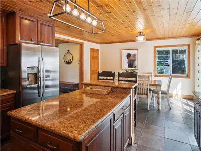 a kitchen with a refrigerator and a counter top at High Sierra Escape - Cozy, Spacious Mountain Home in South Lake Tahoe