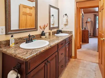 a bathroom with two sinks and two mirrors at High Sierra Escape - Cozy, Spacious Mountain Home in South Lake Tahoe