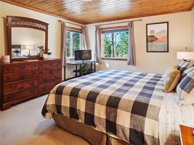 a bedroom with a bed and a dresser and a mirror at High Sierra Escape - Cozy, Spacious Mountain Home in South Lake Tahoe