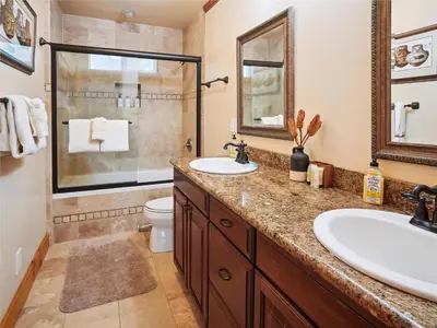 a bathroom with two sinks and a shower at High Sierra Escape - Cozy, Spacious Mountain Home in South Lake Tahoe