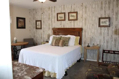 a bedroom with a white bed with pillows on it at The Bonnie Inn Unit 1 in San Andreas