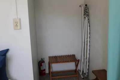 a room with a wooden chair next to a wall at The Bonnie Inn Unit 1 in San Andreas