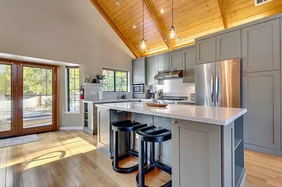a kitchen with a large island with bar stools at Private Ski, Lake & Golf Chalet! Walk to Lake in Tahoe Vista