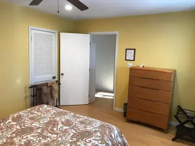 a bedroom with a bed and a dresser and a door at Black Oak Hill Vista near Yosemite - mountain views & starry night sky in Mariposa