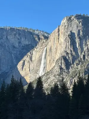 a waterfall on the side of a mountain at Cozy Cub Cabin, brand new home near Yosemite in Mariposa