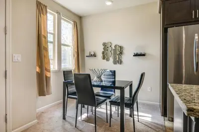 a dining room with a black table and chairs at Charming Patterson Condo with Grilling Stations in Patterson