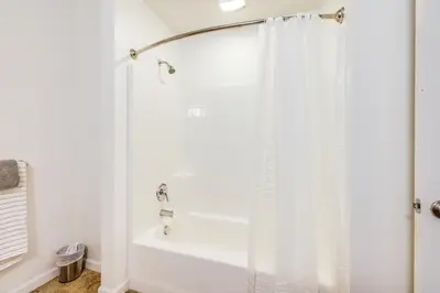 a bathroom with a shower with a shower curtain at Charming Patterson Condo with Grilling Stations in Patterson