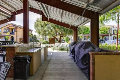 a covered patio with a table and chairs at Charming Patterson Condo with Grilling Stations in Patterson