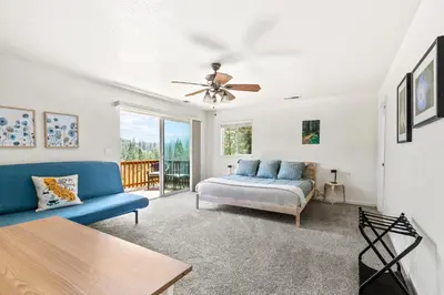 a living room with a bed and a couch at Big Creek Hideaway in Groveland