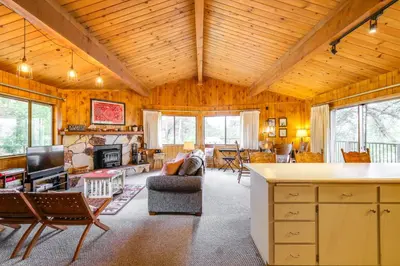 a large living room with a couch and a fireplace at Serene Groveland Cabin Rental Near Yosemite! in Groveland