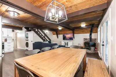 a dining room with a large wooden table and chairs at Rustic and Modern 3BDR Tahoe Cabin in Tahoe City