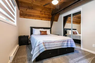 a bedroom with a bed in a room with a window at Rustic and Modern 3BDR Tahoe Cabin in Tahoe City