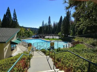 a swimming pool in a yard with a fence and trees at Summer Escape Chalet with Pool Access in BLS in Arnold