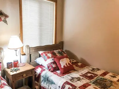 a bedroom with a bed and a table and a window at Summer Escape Chalet with Pool Access in BLS in Arnold