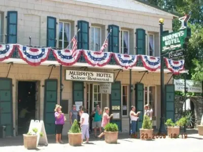 a group of people standing outside of a building with american flags at Summer Escape Chalet with Pool Access in BLS in Arnold