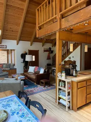 a kitchen and living room with a loft at Gorgeous cabin in BLS with EV Chgr, Pool Access and Gameroom in Arnold