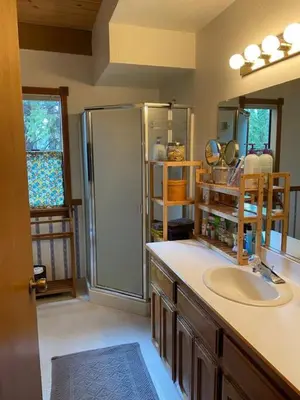 a bathroom with a sink and a shower in it at Gorgeous cabin in BLS with EV Chgr, Pool Access and Gameroom in Arnold