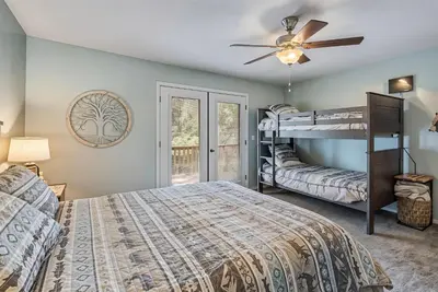 a bedroom with two bunk beds and a ceiling fan at The Nut House - Lovely Home with Hot Tub home in Groveland