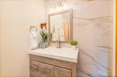 a bathroom with a sink and a mirror at Corlieu Falls Cabin in Sugar Pine 8 miles from Yosemite with Gazebo, Hot tub a shack and Bar top in Oakhurst