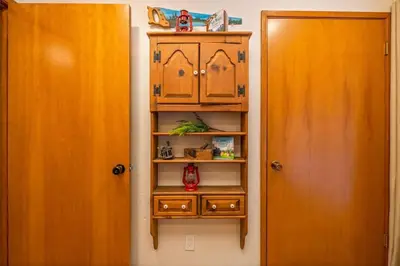 a closet with a wooden cabinet next to a door at Corlieu Falls Cabin in Sugar Pine 8 miles from Yosemite with Gazebo, Hot tub a shack and Bar top in Oakhurst