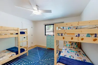 a bedroom with two bunk beds and a ceiling fan at Piney Point in Arnold