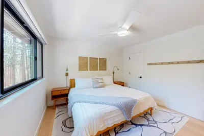 a white bedroom with a bed and a window at Piney Point in Arnold