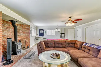 a living room with a couch and a fireplace at Oakhurst Vacation Rental Near Hiking and Bass Lake! in Oakhurst