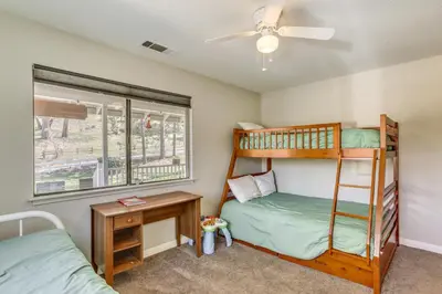 a bedroom with two bunk beds and a window at Oakhurst Vacation Rental Near Hiking and Bass Lake! in Oakhurst