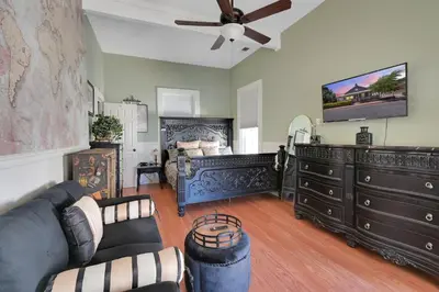 a living room with a couch and a ceiling fan at Spacious Downtown Jackson Retreat- Historic Hangout in Jackson