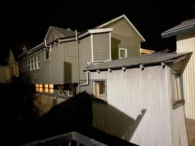 a house at night with a building at Spacious Downtown Jackson Retreat- Historic Hangout in Jackson