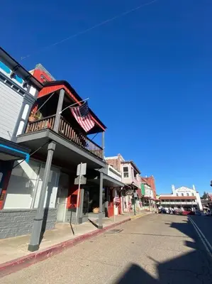 a building with an american flag on the side of a street at Spacious Downtown Jackson Retreat- Historic Hangout in Jackson